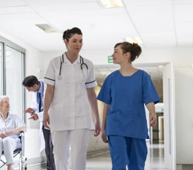 Healthcare professionals in a corridor, denoting MOBATIME's reliable time services for healthcare facilities