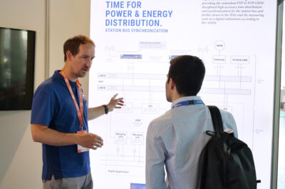 The product manager explains the energy application to a customer using the illuminated wall